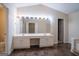 Bright bathroom featuring double sinks, vanity lighting, and an open doorway to the bedroom at 2938 Cottesford Se Way, Smyrna, GA 30080