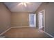 Bedroom with an open door to the en suite bathroom showcasing neutral walls and soft carpet at 2938 Cottesford Se Way, Smyrna, GA 30080
