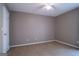 Neutral bedroom with a ceiling fan, neutral carpet, and natural light through the window at 2938 Cottesford Se Way, Smyrna, GA 30080