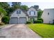 Charming two-story home featuring a well-maintained lawn, two-car garage, and neutral exterior paint at 2938 Cottesford Se Way, Smyrna, GA 30080