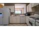 Bright kitchen with white cabinets, stainless appliances, and a view into another room at 2938 Cottesford Se Way, Smyrna, GA 30080