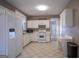 Well-lit kitchen with white appliances, matching cabinets, and checkered flooring at 2938 Cottesford Se Way, Smyrna, GA 30080