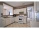 Kitchen with appliances, light-colored cabinets and flooring, open to adjacent room at 2938 Cottesford Se Way, Smyrna, GA 30080