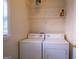 Laundry room showcasing a washer and dryer, along with wire shelving for storage at 2938 Cottesford Se Way, Smyrna, GA 30080