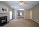 Open living area featuring a fireplace, neutral carpet, and a staircase leading upstairs at 2938 Cottesford Se Way, Smyrna, GA 30080