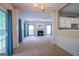Open-concept living area with a fireplace, plush carpet, and access to outdoor space at 2938 Cottesford Se Way, Smyrna, GA 30080