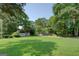 Spacious backyard with outbuildings and large trees, offering ample room for outdoor activities and storage at 315 Jewel Ln, Covington, GA 30014