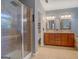 Bathroom featuring double sinks, tile floors, and shower with glass enclosure at 315 Jewel Ln, Covington, GA 30014