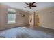 Bedroom with wood-look floors, light neutral walls, and view into the kitchen and hallway at 315 Jewel Ln, Covington, GA 30014