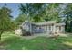 Rear exterior view features a stone patio area and lush lawn, perfect for outdoor entertaining and relaxation at 315 Jewel Ln, Covington, GA 30014
