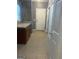 Hallway with tile flooring, neutral paint, and white doors offering ample storage options at 315 Jewel Ln, Covington, GA 30014