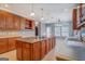 Well-lit eat-in kitchen featuring custom cabinets, tile backsplash, large island, and stainless steel sink at 315 Jewel Ln, Covington, GA 30014