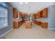 Spacious kitchen with custom cabinets, tile backsplash, stainless appliances, and a large island at 315 Jewel Ln, Covington, GA 30014
