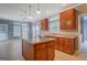 Spacious eat-in kitchen with large island, stainless sink, tile floors, and plentiful natural light at 315 Jewel Ln, Covington, GA 30014