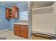 Laundry room with cabinets, countertop, utility sink and built-in shelving at 315 Jewel Ln, Covington, GA 30014