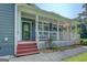 View of the porch, with a decorative storm door, painted red stairs, and well-kept outdoor space at 315 Jewel Ln, Covington, GA 30014
