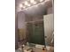 Sleek bathroom mirror reflects a modern shower with glass doors and stylish fixtures, adding a touch of elegance at 2540 Picardy N Cir # B, South Fulton, GA 30349