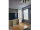 A serene bedroom featuring neutral gray walls, hardwood floors, and bright natural light from the window at 2540 Picardy N Cir # B, South Fulton, GA 30349