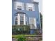 Charming blue home featuring white trim, front yard landscaping, and a brick retaining wall at 2540 Picardy N Cir # B, South Fulton, GA 30349