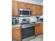 Well-equipped kitchen featuring stainless steel appliances and warm wood cabinets, perfect for culinary enthusiasts at 2540 Picardy N Cir # B, South Fulton, GA 30349