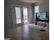 Cozy living room features tile floors, a sliding door to the outside, and a modern entertainment setup at 2540 Picardy N Cir # B, South Fulton, GA 30349