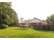 Expansive backyard featuring a swing set, lush lawn, and partial fencing at 30 Carolyn Ct, Social Circle, GA 30025