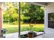 Lush backyard view from the patio, featuring mature trees and green space at 30 Carolyn Ct, Social Circle, GA 30025