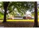 Expansive backyard featuring shade trees and partial view of the house at 30 Carolyn Ct, Social Circle, GA 30025