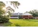 Spacious backyard with lush green lawn, mature trees, and a charming swing set at 30 Carolyn Ct, Social Circle, GA 30025