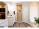 Bright bathroom featuring a glass shower, white vanity, wood-look floors, and a soaking tub at 30 Carolyn Ct, Social Circle, GA 30025