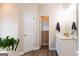 Beautiful bathroom featuring a white vanity, wood-look floors, and an open closet at 30 Carolyn Ct, Social Circle, GA 30025