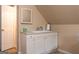 Bathroom vanity with white cabinets, cream counters, and square framed mirror at 30 Carolyn Ct, Social Circle, GA 30025