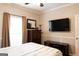 Comfortable bedroom featuring a TV, dresser, and plenty of natural light at 30 Carolyn Ct, Social Circle, GA 30025