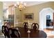 Elegant dining room boasts hardwood floors, decorative molding, and a stylish chandelier, perfect for entertaining at 30 Carolyn Ct, Social Circle, GA 30025