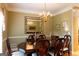 Sophisticated dining area showcasing a classic chandelier, large decorative mirror, and comfortable seating for six at 30 Carolyn Ct, Social Circle, GA 30025