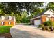 Brick home with a two-car garage featuring mature landscaping and a lamp post at 30 Carolyn Ct, Social Circle, GA 30025