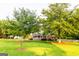 Beautifully landscaped front yard featuring a well-manicured lawn and mature shade trees, enhancing the curb appeal of the home at 30 Carolyn Ct, Social Circle, GA 30025