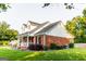 Charming two-story home with a brick and siding exterior, landscaped yard, and inviting front porch at 30 Carolyn Ct, Social Circle, GA 30025