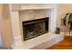 Close-up of a marble fireplace with glass doors, adding a touch of elegance to the living space at 30 Carolyn Ct, Social Circle, GA 30025