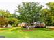 Charming brick home featuring a covered front porch and lush green lawn with mature trees at 30 Carolyn Ct, Social Circle, GA 30025