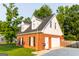 Exterior elevation of the home including a garage with driveway and yard at 30 Carolyn Ct, Social Circle, GA 30025