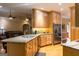 Open kitchen design with light-wood cabinets and stainless-steel appliances at 30 Carolyn Ct, Social Circle, GA 30025