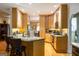 Open kitchen design with light-wood cabinets and granite countertops at 30 Carolyn Ct, Social Circle, GA 30025