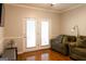 Cozy living room featuring a comfortable couch, stylish decor, hardwood floors, and access to the outdoors at 30 Carolyn Ct, Social Circle, GA 30025