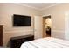 Comfortable main bedroom featuring a flatscreen tv and access to the living room at 30 Carolyn Ct, Social Circle, GA 30025