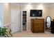 Comfortable main bedroom featuring a flatscreen tv, dresser, and closet for storage at 30 Carolyn Ct, Social Circle, GA 30025