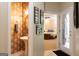 Elegant powder room with patterned wallpaper, pedestal sink, and adjacent entry into the main bedroom at 30 Carolyn Ct, Social Circle, GA 30025