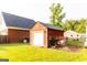 Backyard view of a red storage shed on a sunny day at 30 Carolyn Ct, Social Circle, GA 30025