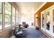 Bright sunroom with brick accents, ceiling fan and plentiful natural light at 30 Carolyn Ct, Social Circle, GA 30025
