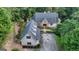 Aerial view of the house with inviting front entrance, well-manicured landscaping, stone details, and mature trees at 223 Old Rome Rd, Kingston, GA 30145